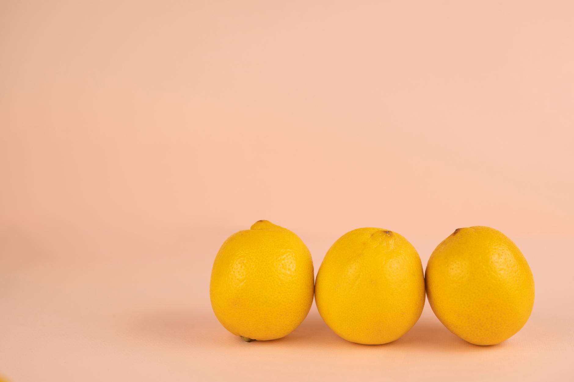 Bright ripe lemons arranged on a pastel background, symbolizing fresh sensations and beginner exploration